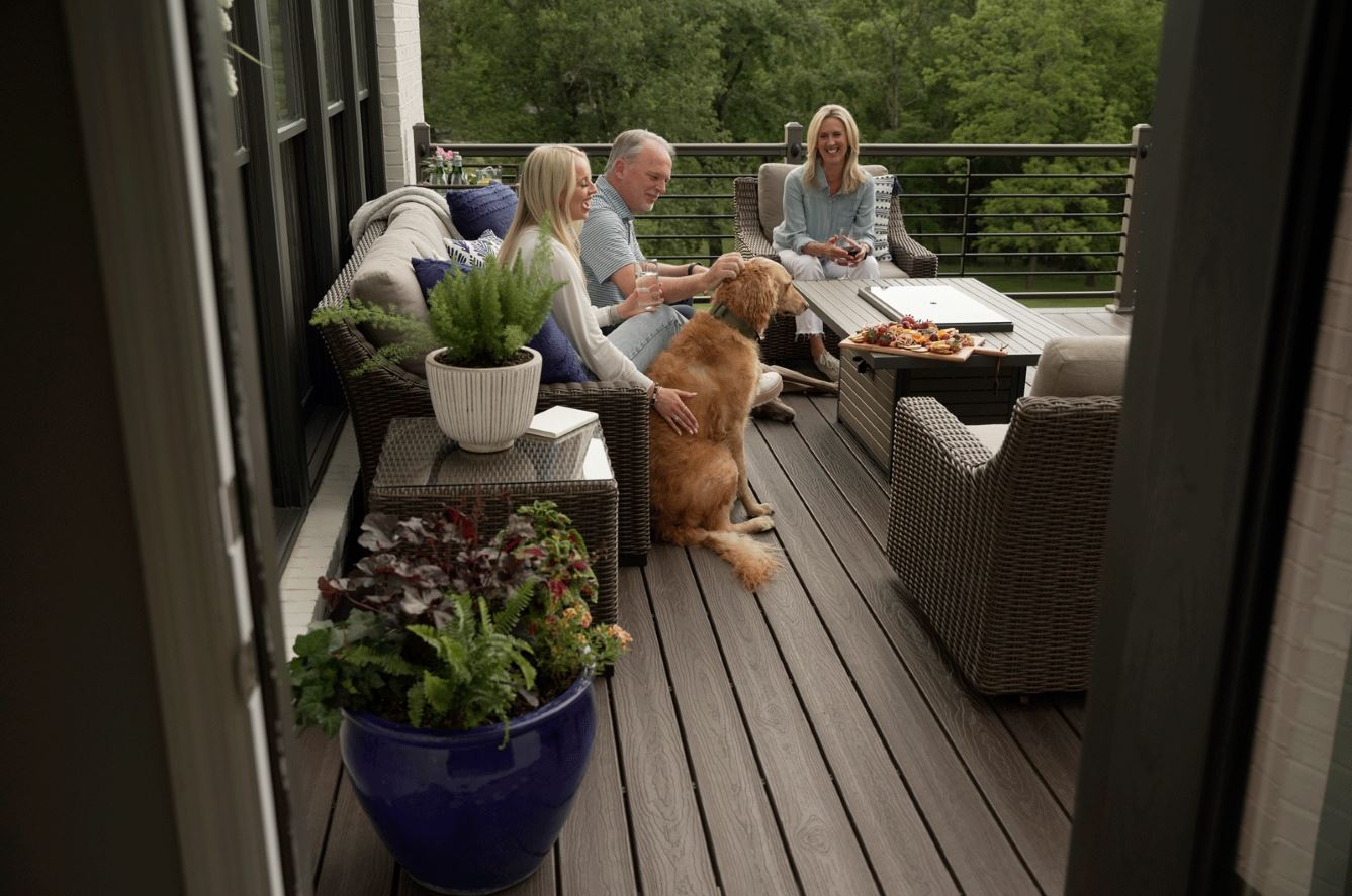 Family relaxing with dogs on an outdoor living space
