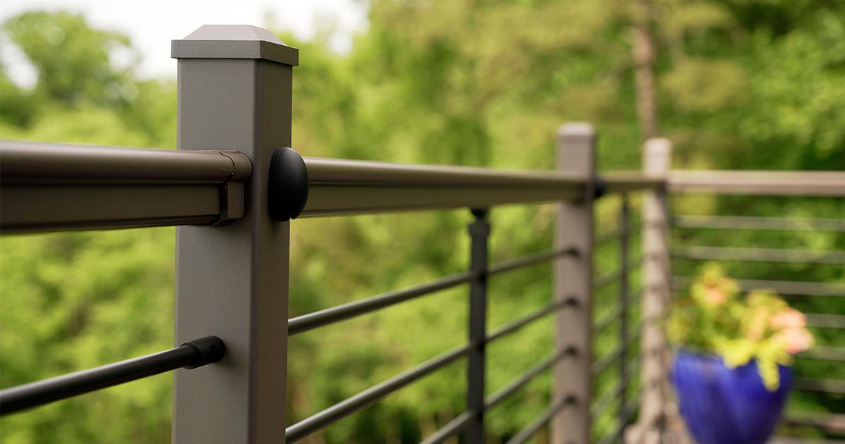An outdoor living space with Fairway textured bronze aluminum deck railing.