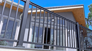 An Envision outdoor living space with black aluminum deck railing.