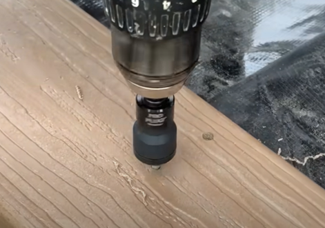 Pro Plug tool drilling into deck board to fasten deck board