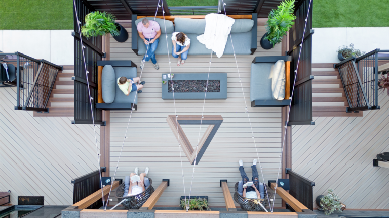 Outdoor living space with composite decking and metal deck railing.