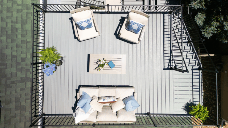Outdoor living with grey composite deck boards and steel deck railing.