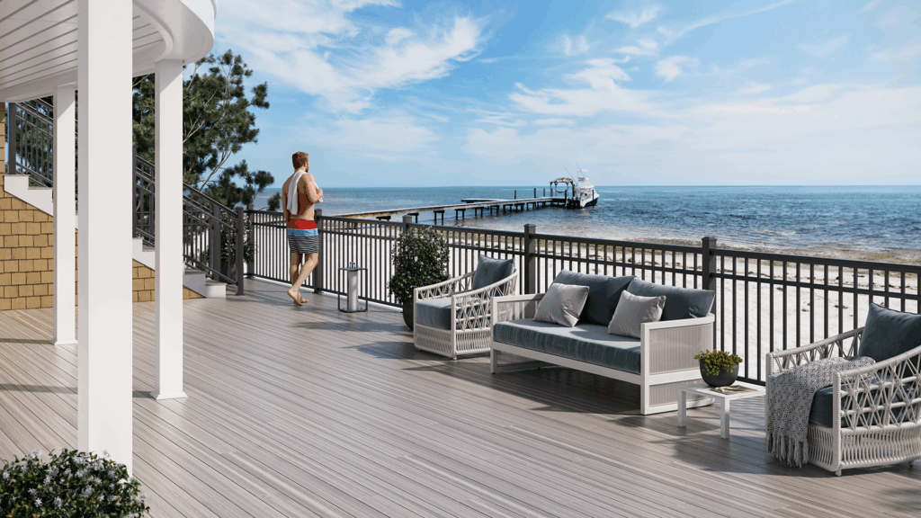Outdoor living space with grey composite deck boards and aluminum deck railing.